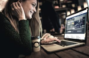 Young woman using laptop in cafe